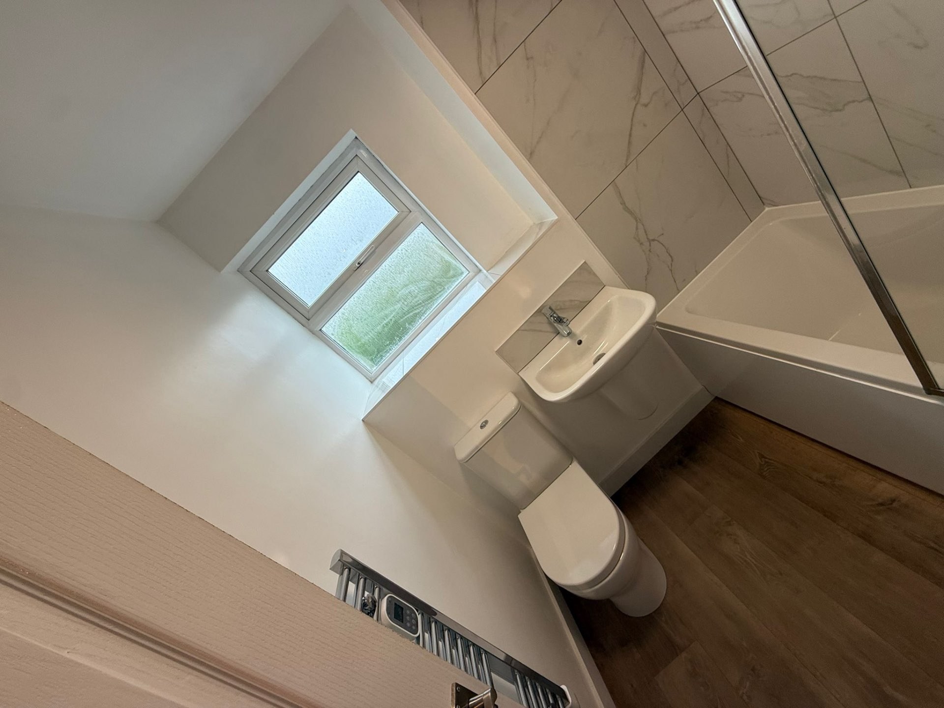 Bright family bathroom with bath, shower screen and fitted vanity